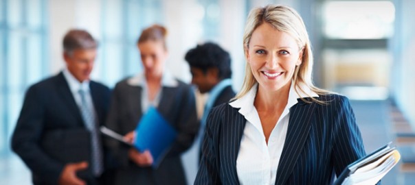A woman in business attire smiling for the camera.